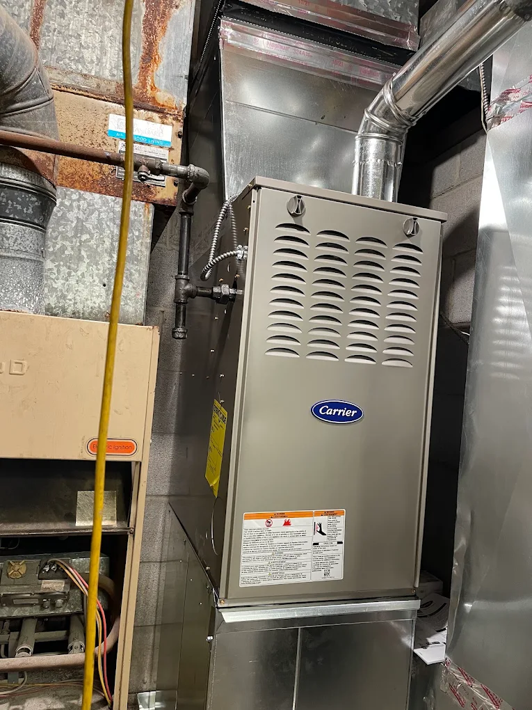 Carrier gas furnace replacement with new venting and gas piping — Annapolis, MD. Carrier high-efficiency gas furnace installed in an Annapolis, Maryland basement with new flue and gas piping