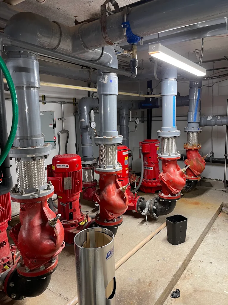 Commercial hydronic pump and boiler room service — Annapolis, MD. Commercial boiler room with Armstrong pumps, flex connectors and hydronic piping serviced in Annapolis, MD