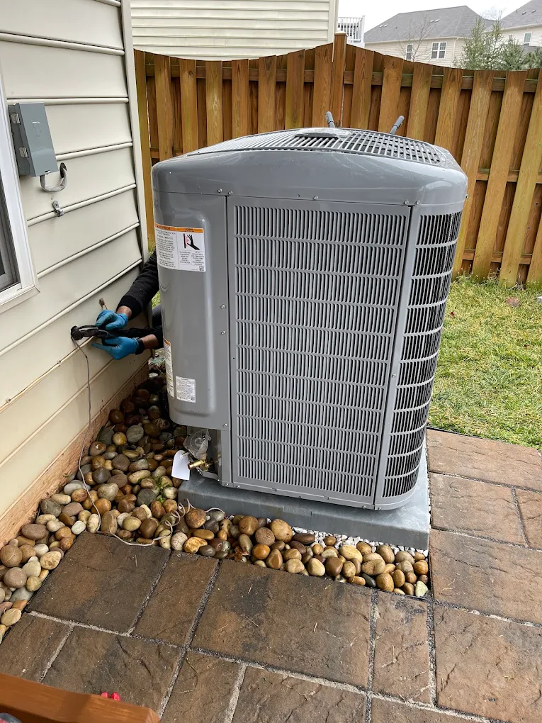 Heat pump installation and line-set hookup — Severna Park, MD. ProActive HVAC technician wiring a new heat pump outdoor unit at a Severna Park, MD home